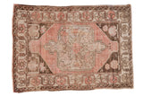 Distressed Oushak rug, dusty blush trefoil medallion, ivory field, chocolate border.