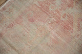 Close-up of the low hand-knotted pile on a distressed Oushak runner, showing its texture.