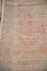 Hand-knotted pile of a distressed Turkish Oushak rug showing mostly even, low wear.