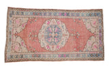 Vintage Distressed Oushak rug, roundel medallion, floral accents, cochineal red, denim blue.