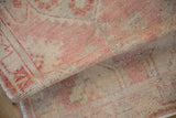 Distressed Oushak rug runner pile texture with faded dusty rose, beige, and woven weft colors.