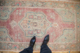 Overhead perspective showing the scale and time-softened texture of a vintage Oushak rug.