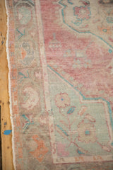 Worn texture of the boteh main border with its intact side selvage on a distressed Oushak rug.