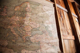 Muted green and brown map of Eastern Europe and Middle East, showing aged canvas texture.