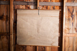 Aged canvas map's bottom corner, showing muted tones and rustic texture.