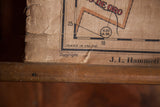 Aged bottom corner of antique canvas map, showing creased texture and maker J.L. Hammett.