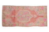 Distressed vintage Turkish Oushak runner with raspberry red medallion, fuchsia florals, soft beige tones. 2'11