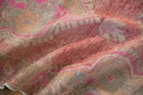 Textured distressed Oushak runner pile with fuchsia, raspberry red, and beige floral designs.