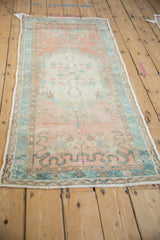 Distressed Oushak runner, close view of soft peach abrashed field and blue-green cloudband.