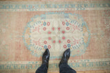 Vintage Distressed Oushak rug runner with abrashed field and faded floral blossoms.
