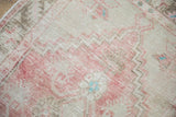 Low-pile texture and even wear on a vintage distressed Oushak rug in rose and platinum.