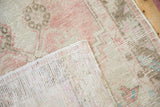 Detail of the hand-knotted foundation and distressed pile on a vintage Oushak runner.