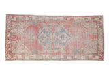 Hand-knotted Vintage Oushak runner with shield-like medallion in faded blush, slate blue, and sand.
