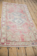 Distressed pile texture and intact side selvage on a vintage Oushak rug runner, in blush and slate blue.
