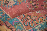Distressed vintage Oushak runner pile, featuring dusty raspberry red and patterned turquoise border.