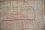 Faded blush and oxidized silver Oushak rug showing distinct weft striations and wear.