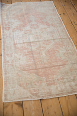 Vintage distressed Oushak runner showing textured wear, blush and ivory tones, and striations.