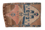 Distressed vintage Kars rug with a tree of life design in dusty rose, sapphire blue, and coffee brown.
