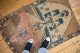 Distressed vintage Turkish rug with a folk art tree of life in coffee brown and dusty rose.