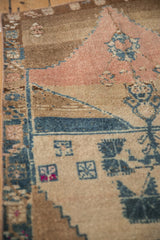 Hand-knotted wool pile on a Kars rug with dusty rose and sapphire blue floral motifs.