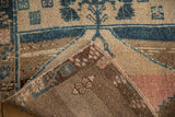 A vintage Kars rug's folded corner reveals its hand-knotted construction and dense wool pile.