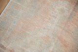 Mostly even wear showing the hand-knotted texture of a distressed vintage Oushak rug.