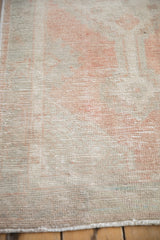The soft, distressed texture of a vintage Oushak rug pile worn to the knot heads.