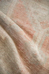 Close-up of the distressed Turkish Oushak runner's soft texture and even wear to the knot heads.