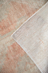Hand-knotted foundation and distressed low-pile texture of a vintage Turkish Oushak runner.