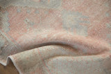 Distressed Oushak rug runner pile with soft cantaloupe melon and dusty rose hues.