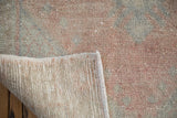 Hand-knotted foundation and distressed cantaloupe-pink pile of the vintage Oushak runner.