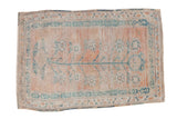 Vintage distressed Oushak rug with a central tree of life design in faded saffron and dusty teal.