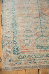 Evenly worn pile and dusty teal serpent border on a vintage distressed Turkish Oushak rug.