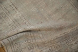 Soft drape showing the time-worn texture and mostly even wear of a vintage Oushak rug.