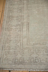 Distressed pile and geometric starburst border on a vintage tone-on-tone Oushak rug.