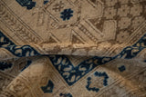 Distressed texture of vintage Afghani rug, showing sapphire blue and tone-on-tone geometric motifs.