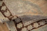 Vintage distressed Oushak rug pile with dusty melon abrashes and chocolate geometric patterns.