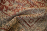 Distressed texture of a vintage Anatolian rug with faded burnt orange and antique ivory patterns.
