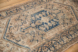 Vintage distressed Hamadan rug close-up, highlighting worn knot heads, blue serpent, and Herati motifs.