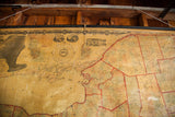 Detailed view of the ornate border and compass rose on the antique canvas NY map.