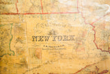 Title cartouche and publisher's imprint on the antique 1860 New York pull-down map.