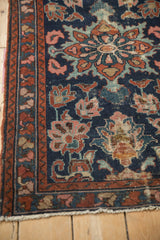 Vintage Mehreban rug border detail with madder red vines and worn cobalt floral field.