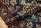 Worn pile of a vintage Mehreban rug, featuring blue, copper, and rose floral motifs.