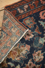 Vintage Mehreban rug's worn pile revealing foundation, cobalt blue, madder red floral motifs, and hand-knotted back.