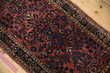 Detailed view of the even pile and delicate blossom contouring on an antique Sarouk rug.