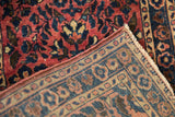 Close-up of the dense wool pile and hand-knotted foundation of a fine Persian Sarouk rug.