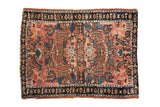 Small antique Lilihan rug with allover floral palmettes on a dusty rose field, framed by a dark navy border.