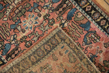 The folded corner of an antique Lilihan rug reveals its hand-knotted foundation.