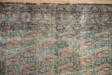 Antique Kerman rug's intricate boteh and Rococo leaf pattern with visible foundation.