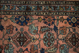 Antique Mehriban rug with dusty rose field, sapphire blue palmettes, and serrated leaves.